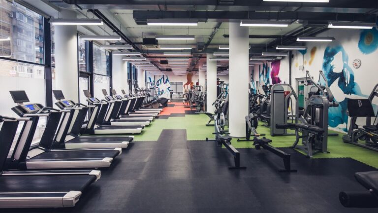 Large group of exercise machines in an empty gym